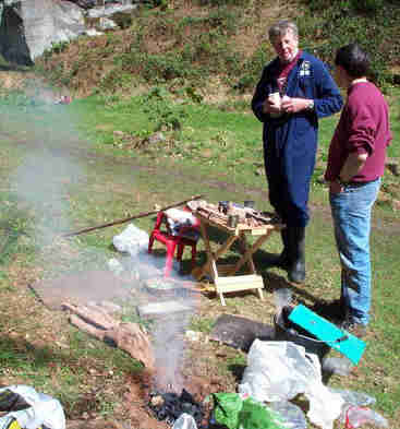 Dave and Pete watch the furnace in Church Quarry.  The bellows can be seen on the far side of the smoking furnace.